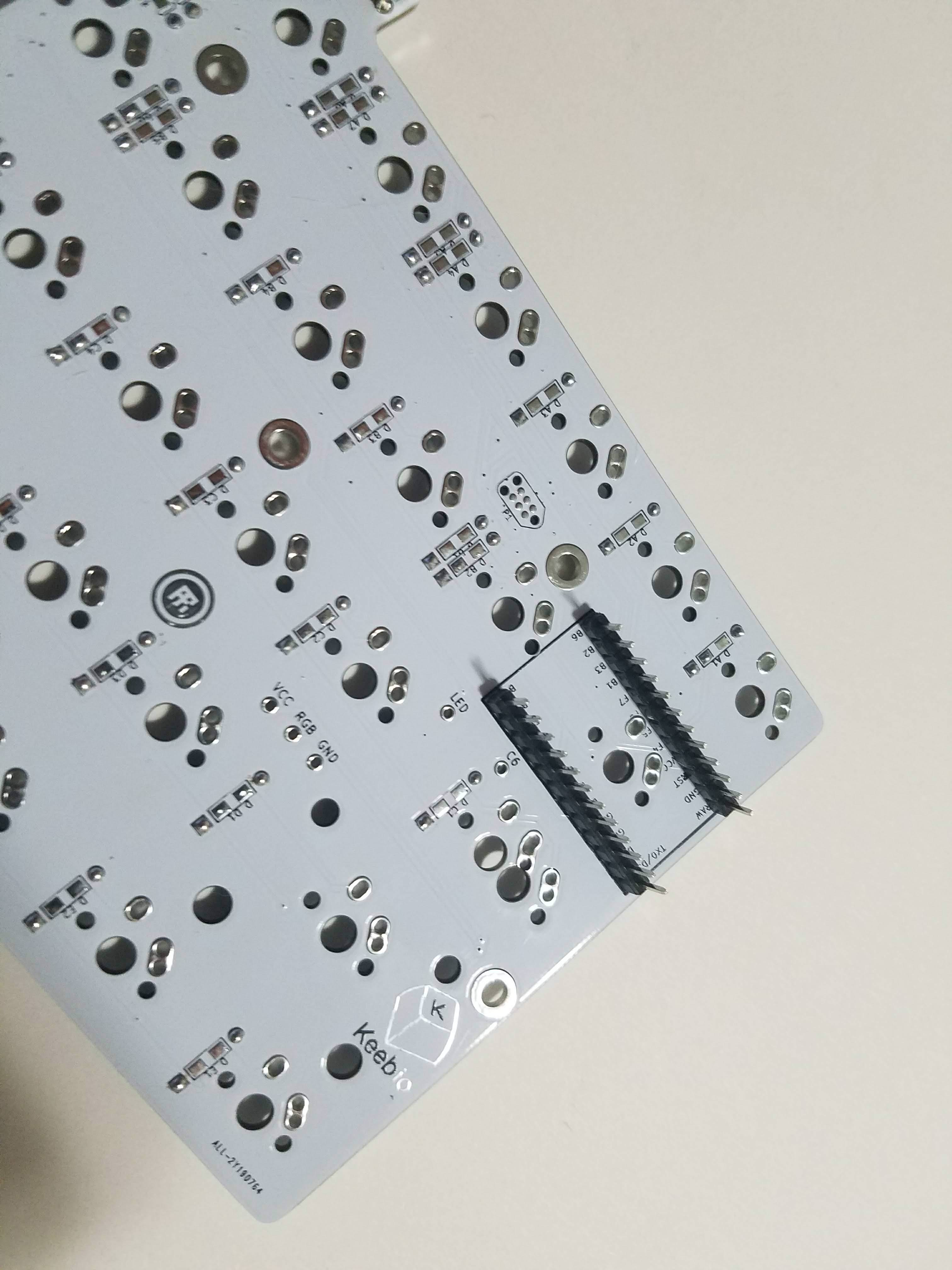 PCB corner with Pro Micro header pins inserted