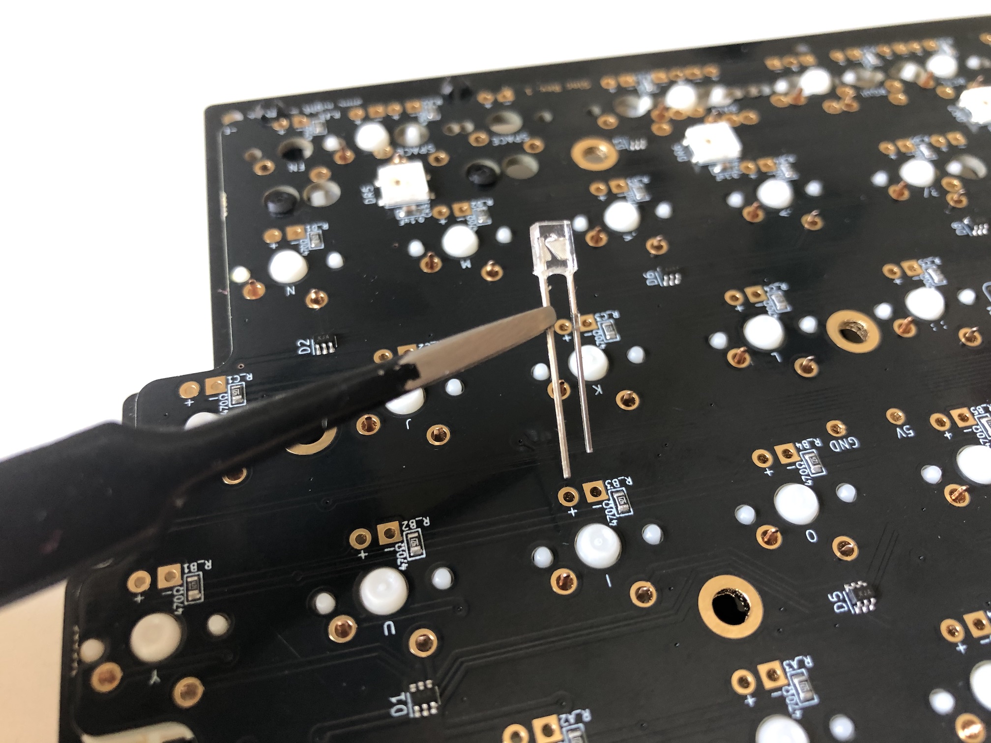 LED held with tweezers showing polarity