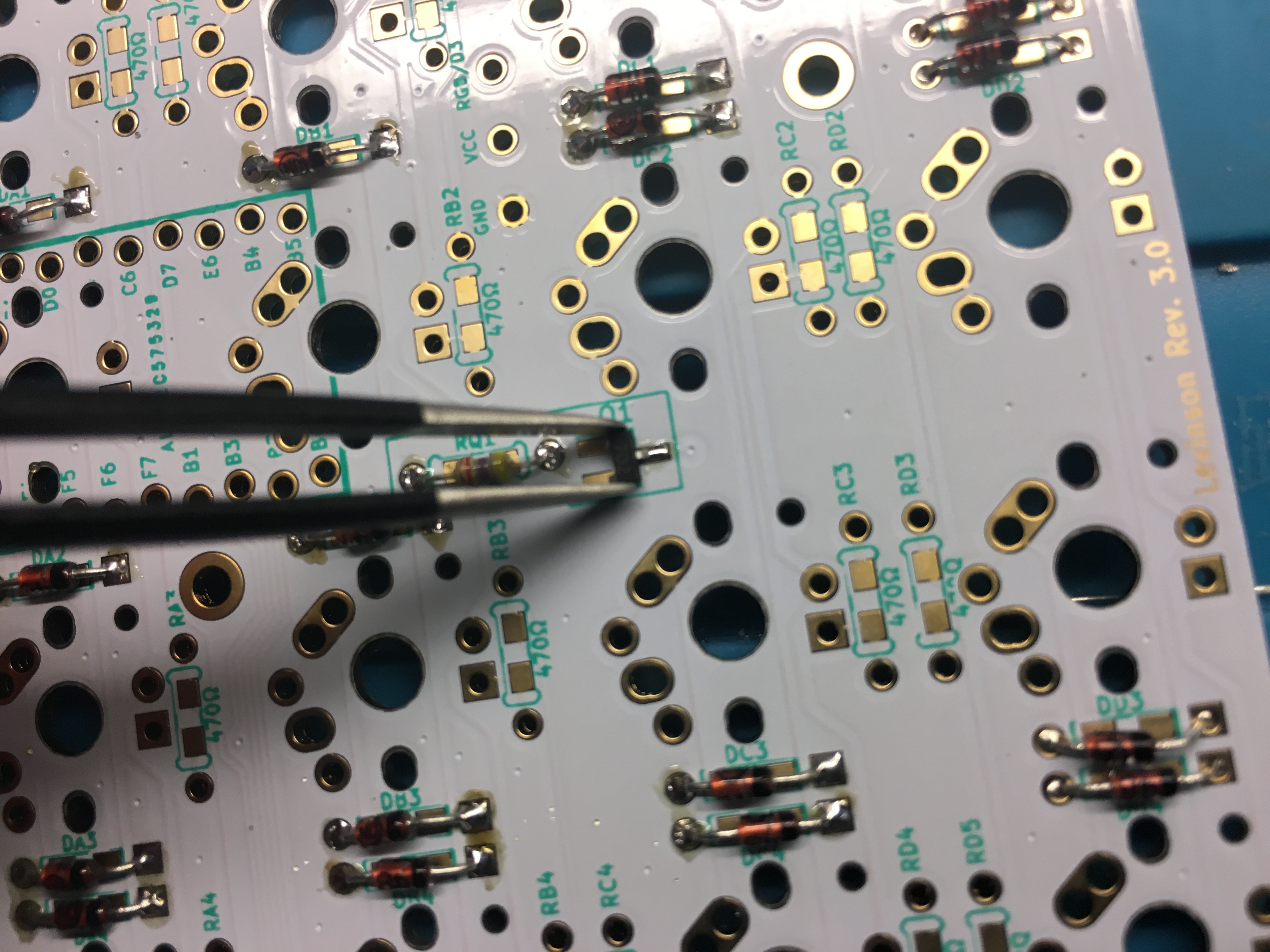 Tweezers Placing Transistor on PCB