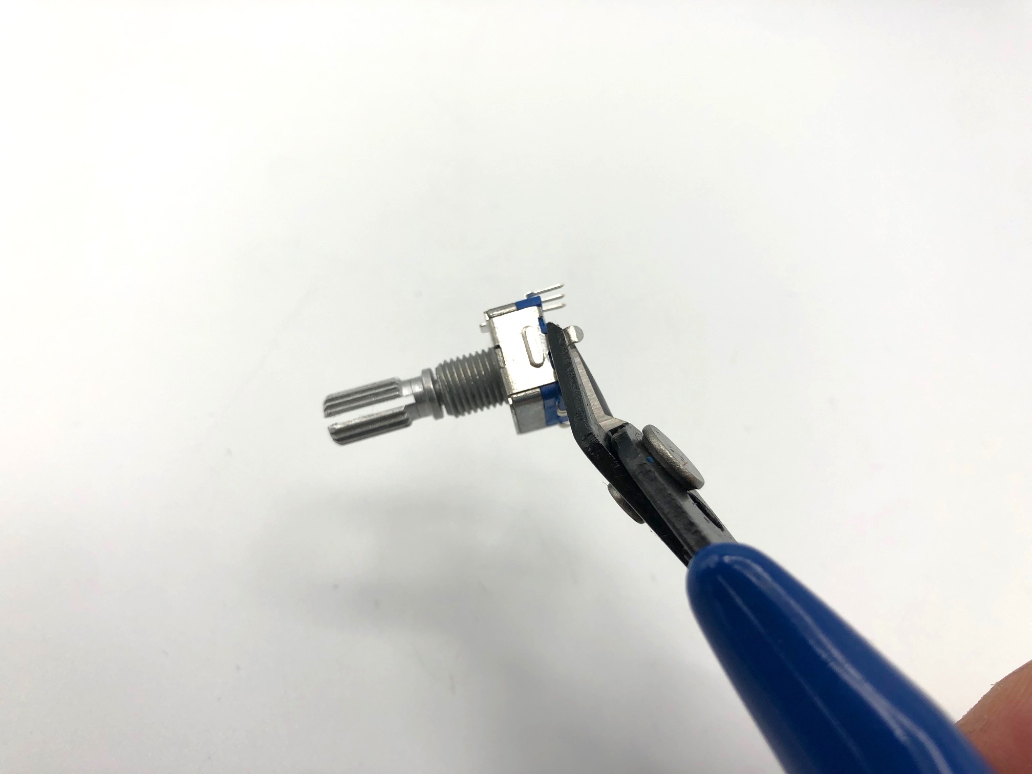 Clipping encoder mounting pins with flush cutters