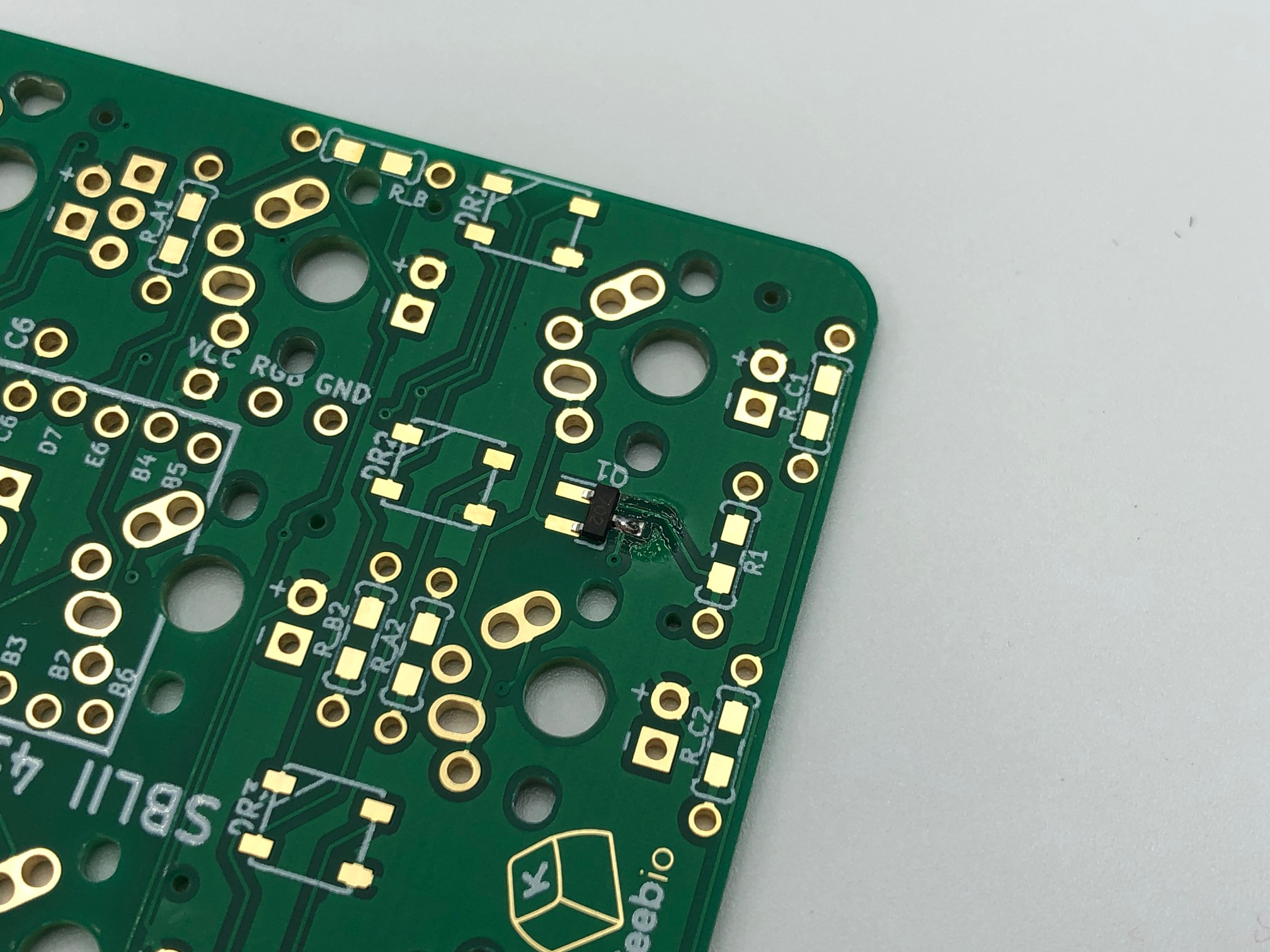Tweezers Holding MOSFET on Pad