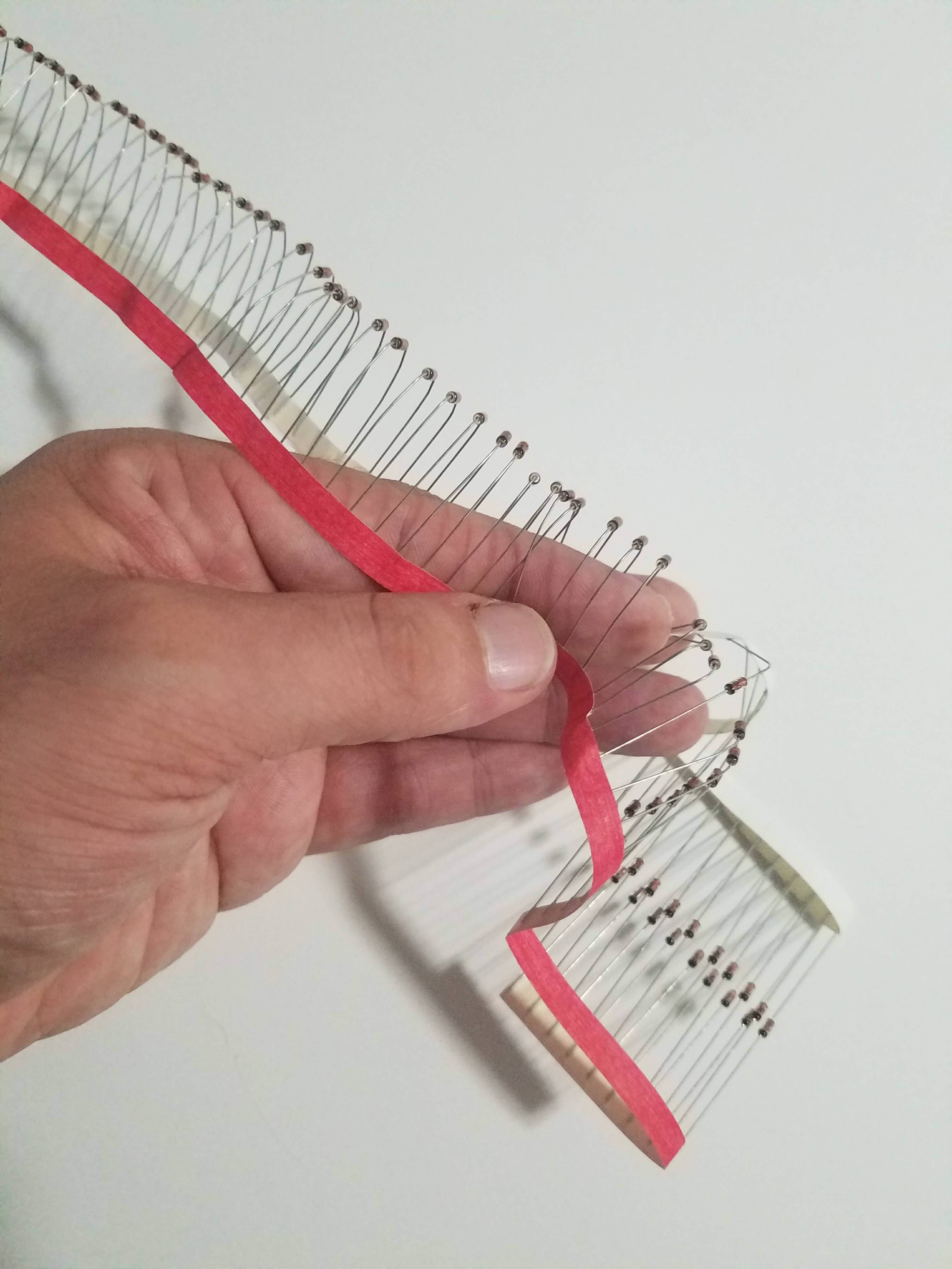 Hand bending diodes on paper strip