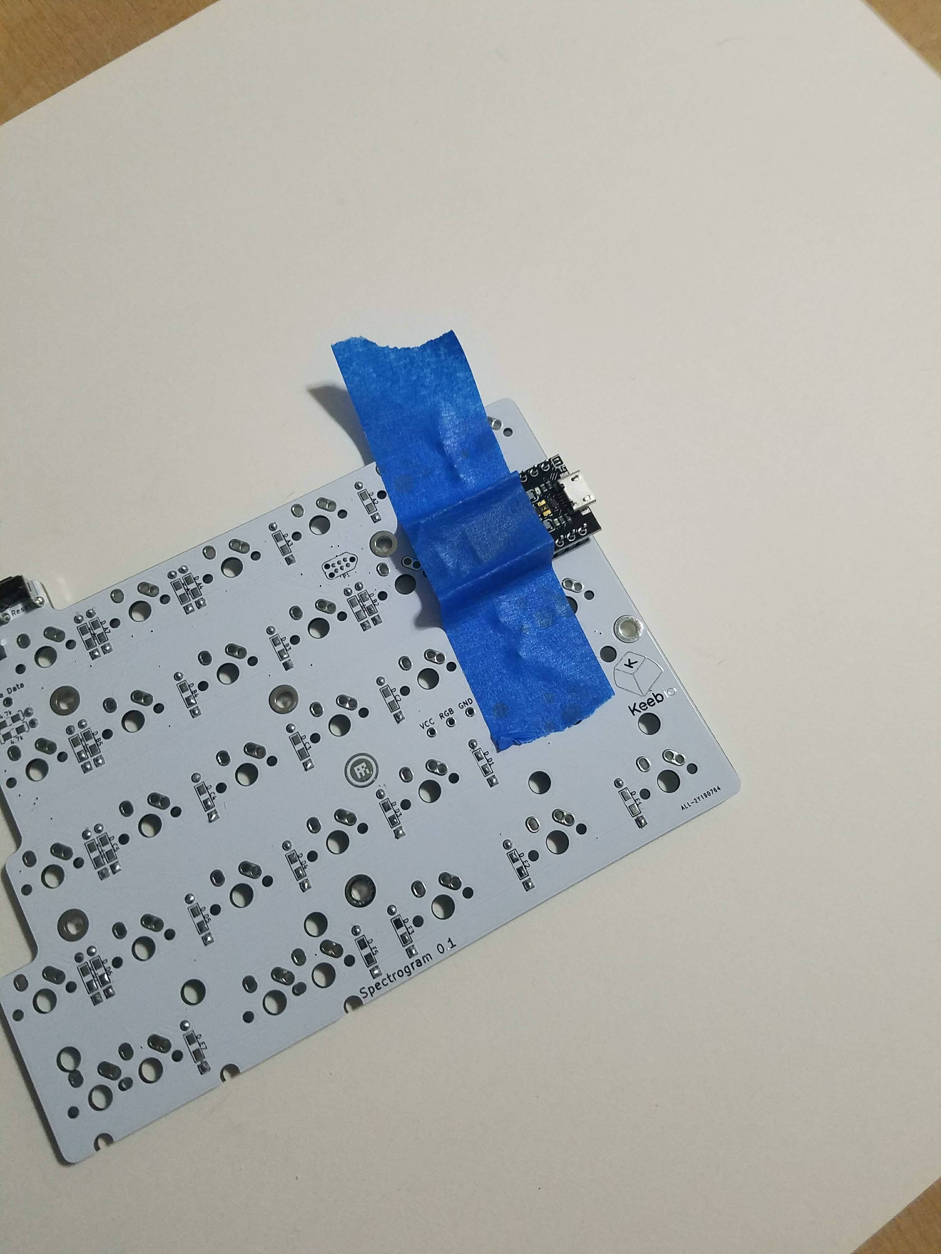 Pro Micro taped to PCB for header pin alignment
