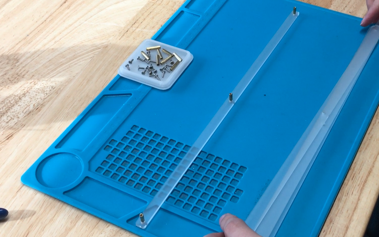 Acrylic foot piece laid flat with screws