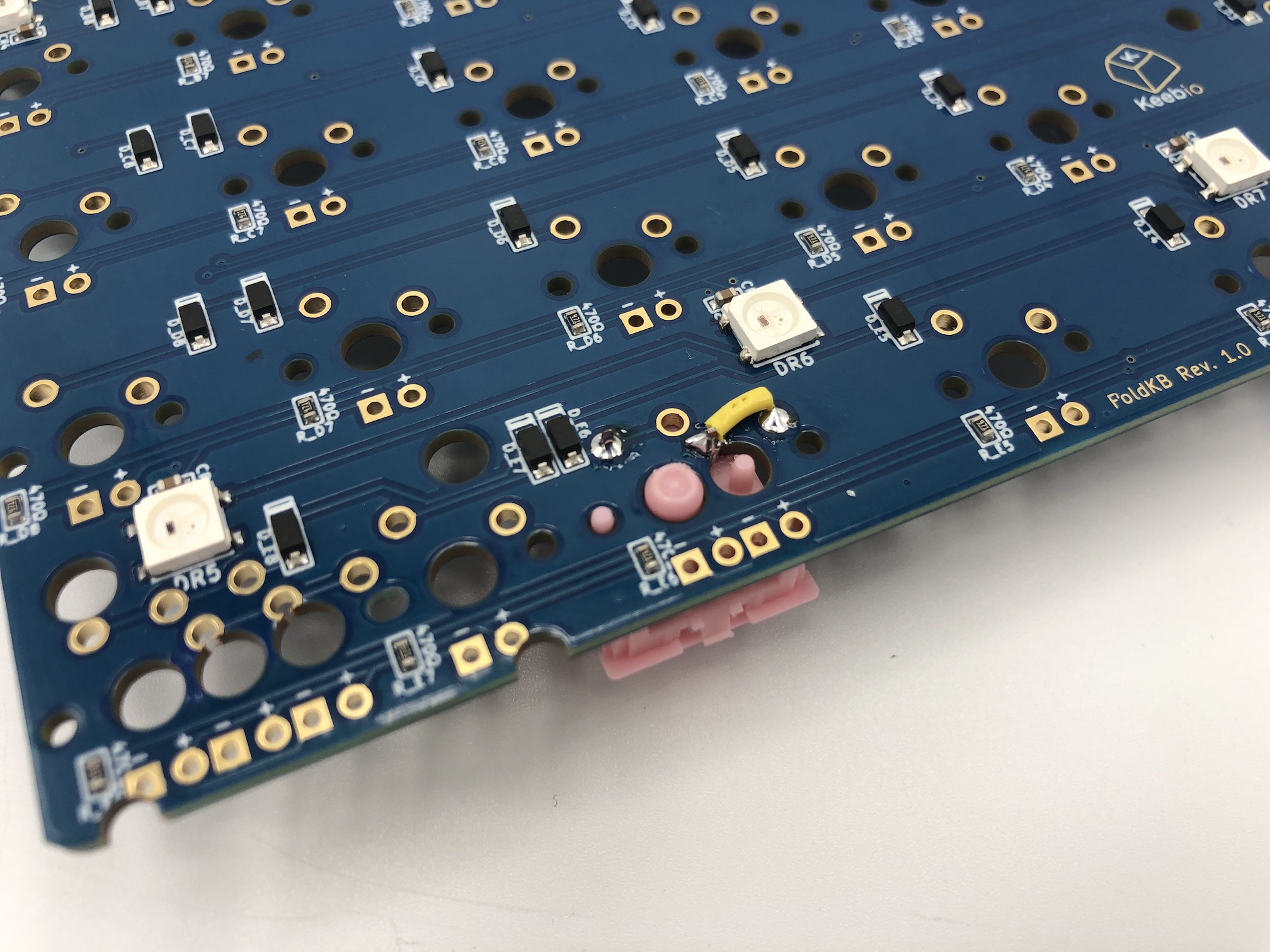 Jumper wire soldered between pins to fix missing trace